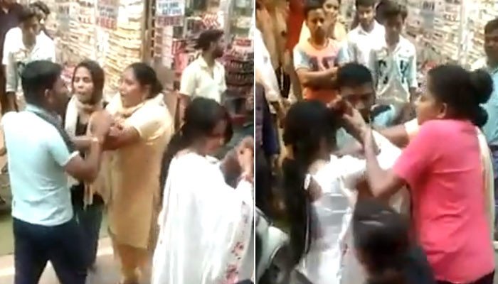 The wife made her husband angry by seeing her girlfriend shopping in the crowded market