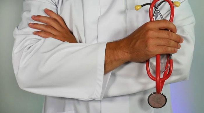 Why do doctors around the world wear white coats?