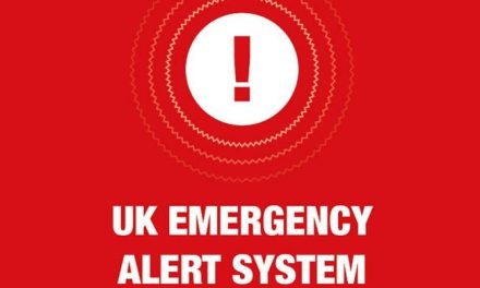 When will the trial of the first emergency alert system begin in the UK?