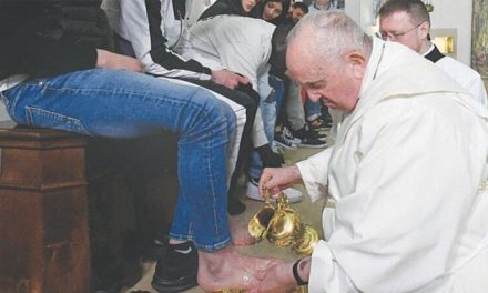 Why did Pope Francis wash the feet of teenage prisoners and kiss them?